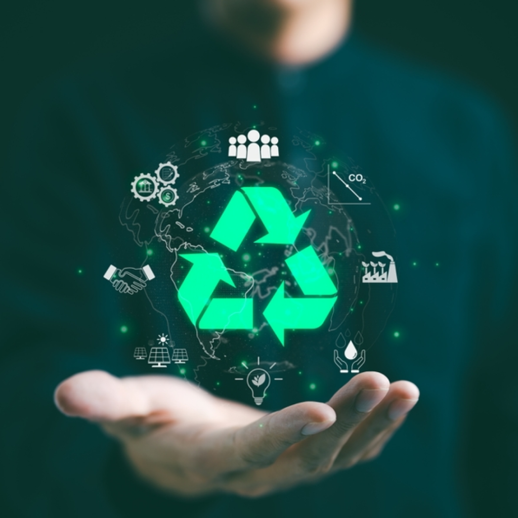 Image showing a hand holding a glowing green recycling symbol surrounded by icons representing sustainability and green technology, such as renewable energy, CO2 reduction, eco-friendly practices, and collaboration, with the Earth in the background symbolizing global environmental efforts.